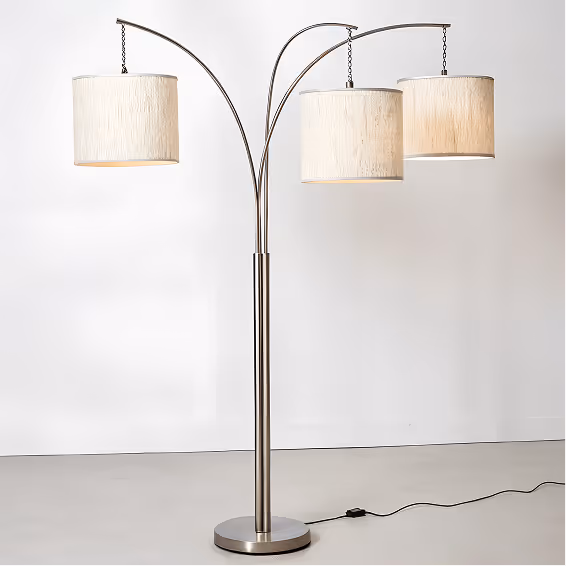 Modern floor lamp with three adjustable arched arms, each holding a beige cylindrical lampshade.