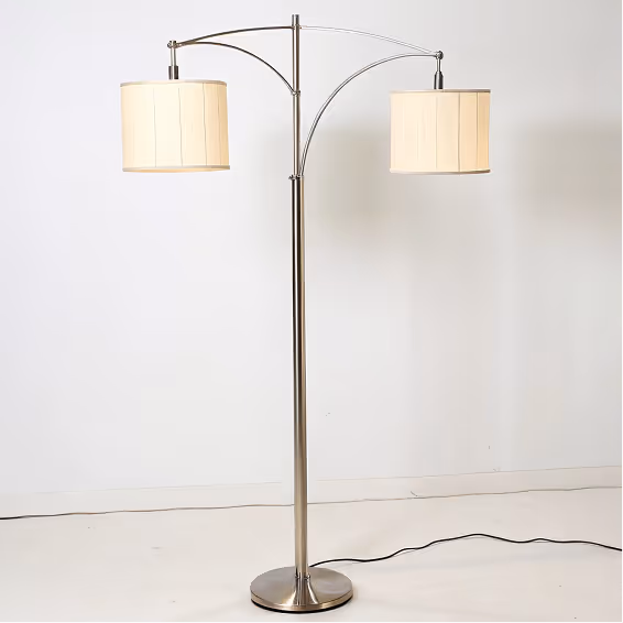 Modern floor lamp with brushed metal stand and two adjustable cream-colored drum lampshades.